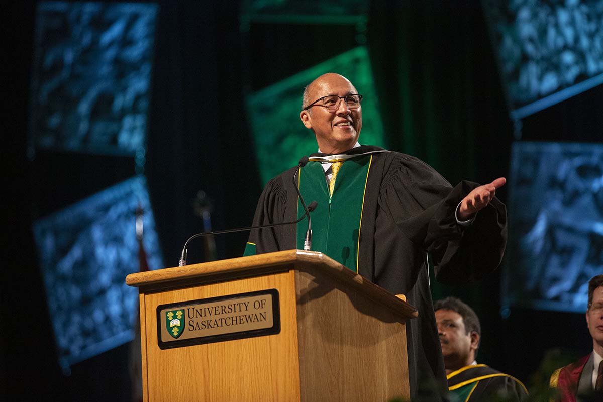A photo showing a smiling man receiving an honorary doctorate from the University of Saskatchewan. 